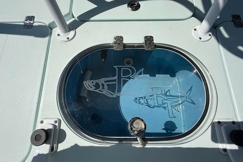 Slide: The Image of 2016 Beavertail Skiffs Vengeance livewell with etched fish design and secure latches. - 13
