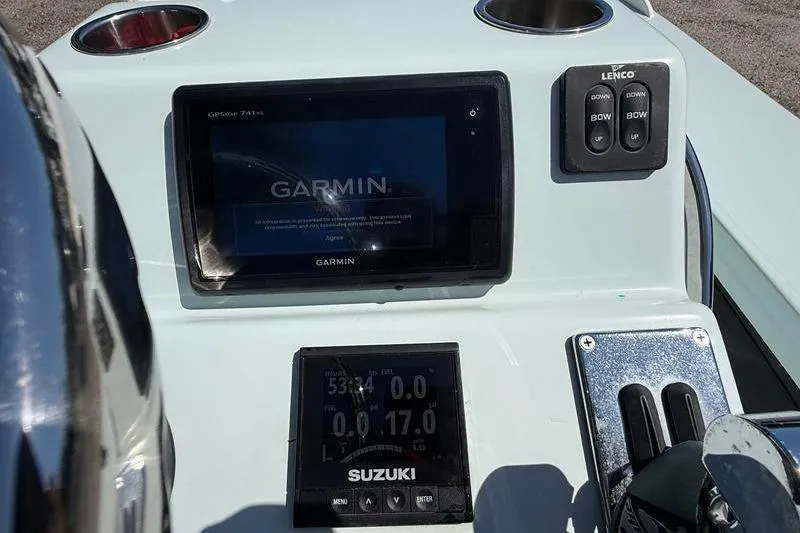 Slide: The Image of 2016 Beavertail Skiffs Vengeance dashboard with Garmin and Suzuki displays. - 16