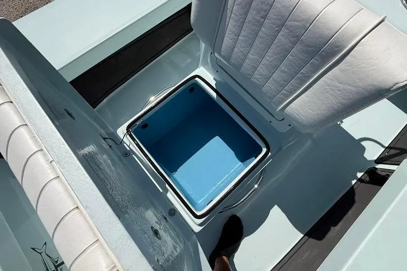 Slide: The Image of 2016 Beavertail Skiffs Vengeance boat interior with open storage compartment and cushioned seating. - 21