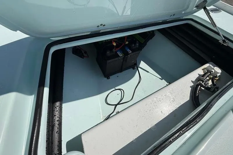 Slide: The Image of 2016 Beavertail Skiffs Vengeance boat compartment with battery and wiring. - 22