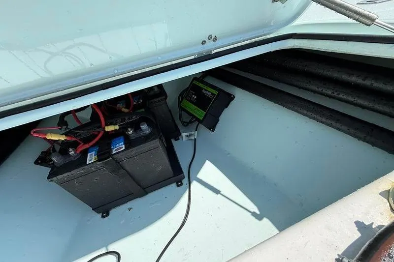 Slide: The Image of 2016 Beavertail Skiffs Vengeance battery compartment with wiring and charger. - 23
