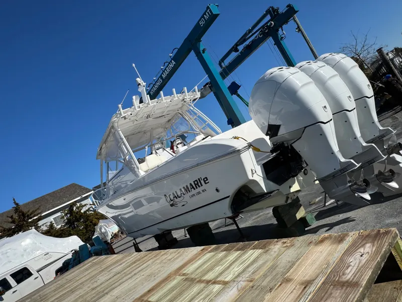 Slide: The Image of 2007 Fountain 38 Sportfish Cruiser with triple outboard engines at the marina. - 2