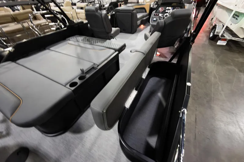 Slide: The Image of 2026 Godfrey Sweetwater 22' Tritoon interior with flip lounge seating and modern design. - 22