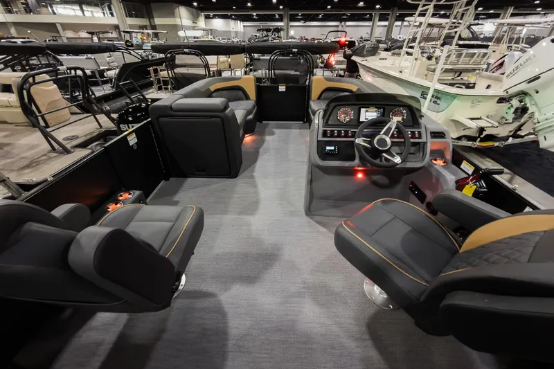 Slide: The Image of Interior of 2026 Godfrey Sweetwater 22' Tritoon with modern seating and control panel. - 26