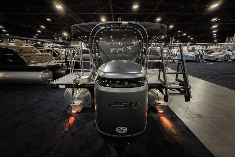 Slide: The Image of 2026 Godfrey Sweetwater 22' Tritoon boat displayed indoors, featuring a powerful 250 engine. - 28