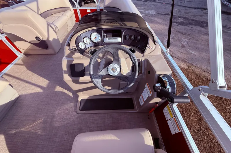 Slide: The Image of 2023 Sun Tracker Party Barge 18 DLX steering console with gauges and controls. - 9
