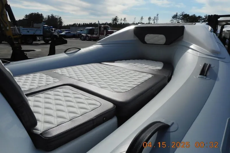 Slide: The Image of 2025 Highfield Sport 420 boat interior with quilted seating, parked outdoors. - 4