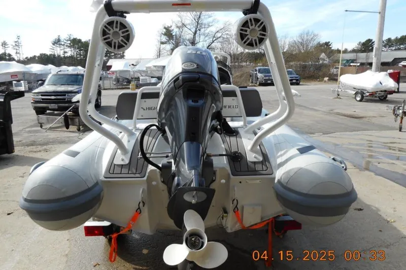Slide: The Image of 2025 Highfield Sport 420 inflatable boat with motor, parked outdoors. - 7