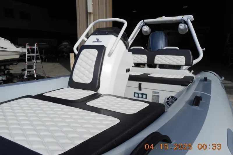 Slide: The Image of 2025 Highfield Sport 420 boat with cushioned seating and modern design in a storage area. - 9