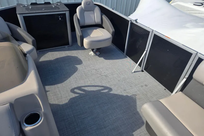 Slide: The Image of 2026 Princecraft Jazz 19-4S pontoon boat interior with seating and steering wheel. - 10