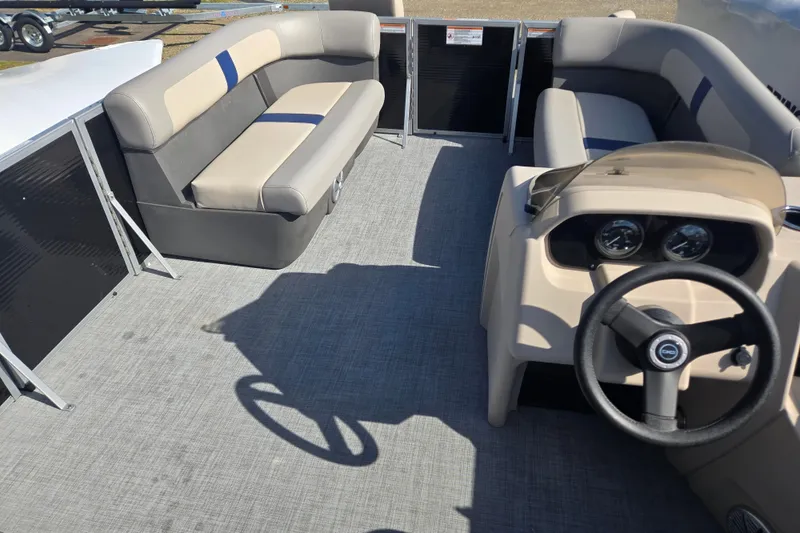 Slide: The Image of 2026 Princecraft Jazz 19-4S pontoon boat interior with seating and steering console. - 11