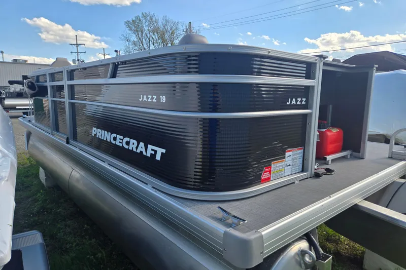Slide: The Image of 2026 Princecraft Jazz 19-4S pontoon boat with sleek black exterior and modern design. - 6