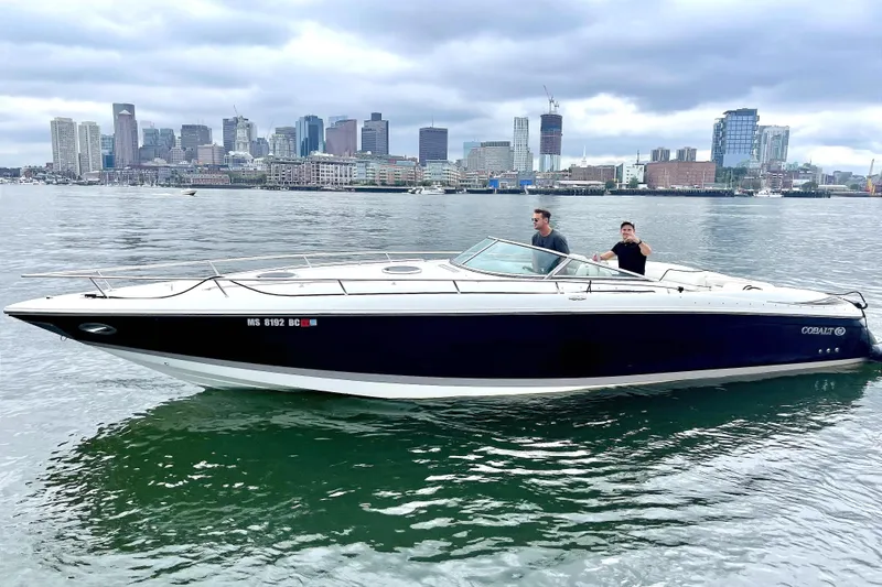 Slide: The Image of 2005 Cobalt 343 boat cruising on water with city skyline in background. - 3