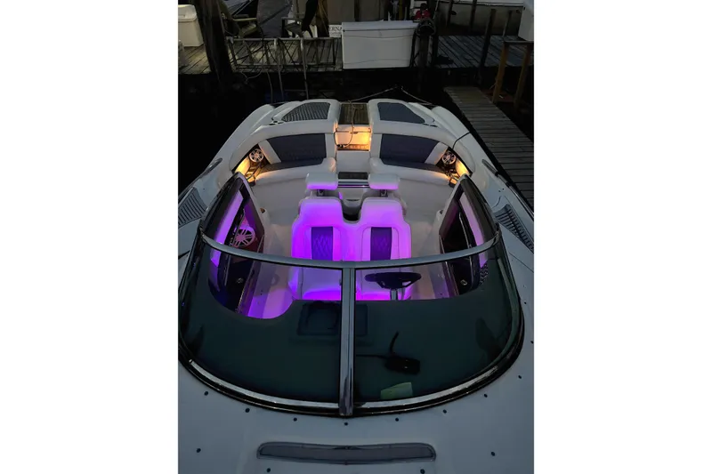 Slide: The Image of 2005 Cobalt 343 boat interior with purple ambient lighting at a dock. - 5