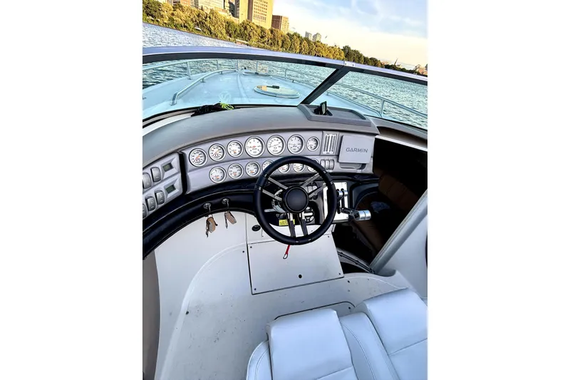 Slide: The Image of Cockpit of a 2005 Cobalt 343 boat with steering wheel and gauges, on a scenic waterway. - 7