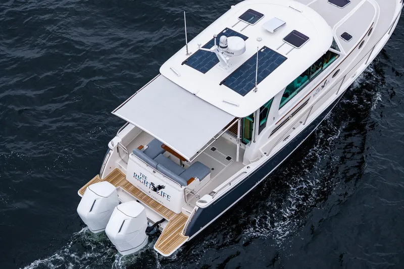 Slide: The Image of 2025 Back Cove 39O yacht cruising on water, featuring dual outboard engines. - 17