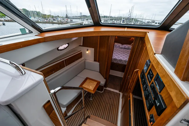 Slide: The Image of Interior of 2025 Back Cove 39O yacht, featuring cozy seating and elegant wood finishes. - 26