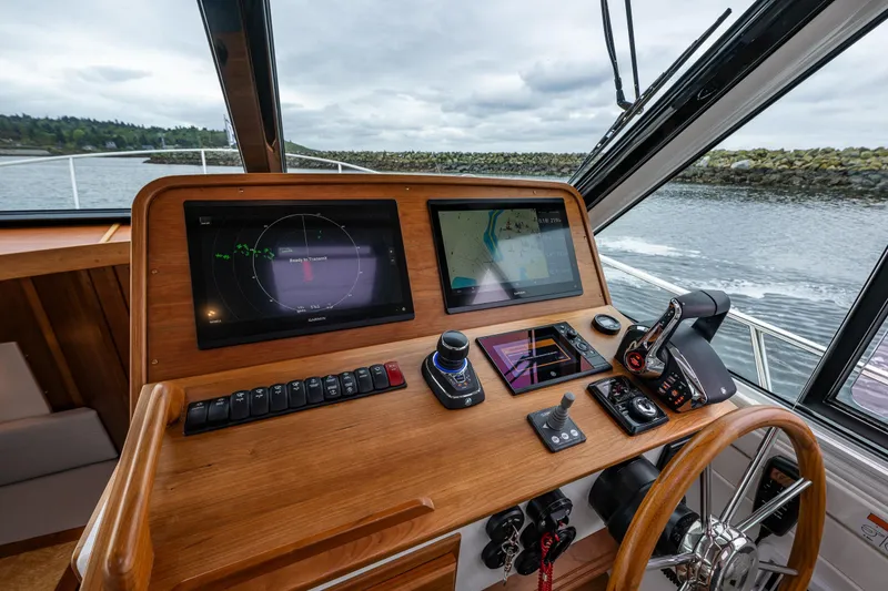 Slide: The Image of Helm of 2025 Back Cove 39O boat with advanced navigation displays and controls. - 30