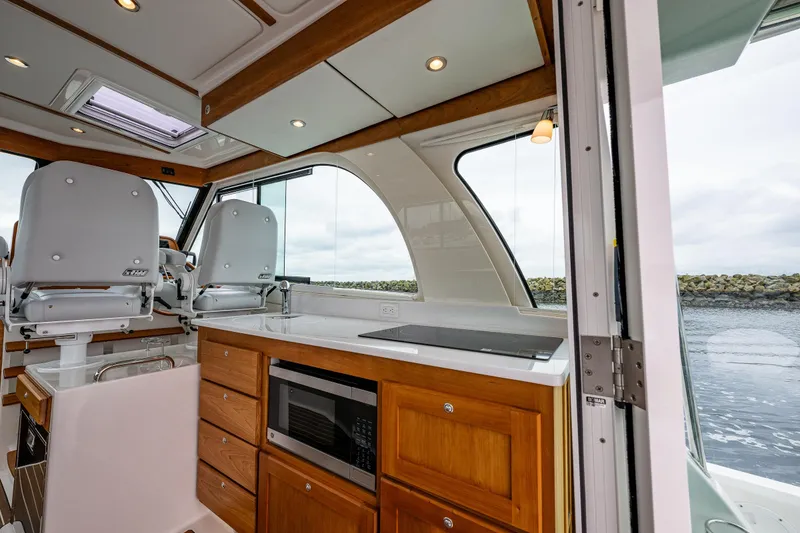 Slide: The Image of Interior of 2025 Back Cove 39O yacht with modern kitchen and seating area. - 35
