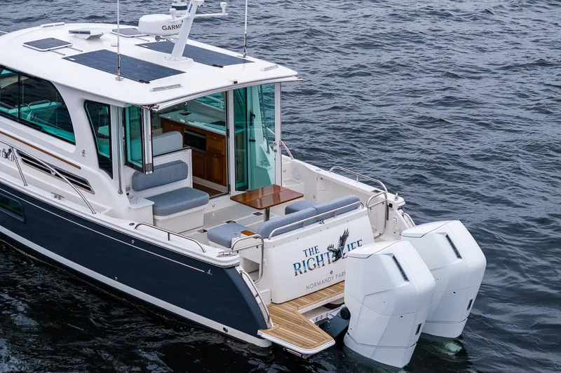 Slide: The Image of 2025 Back Cove 39O yacht on water, featuring sleek design and dual outboard engines. - 5