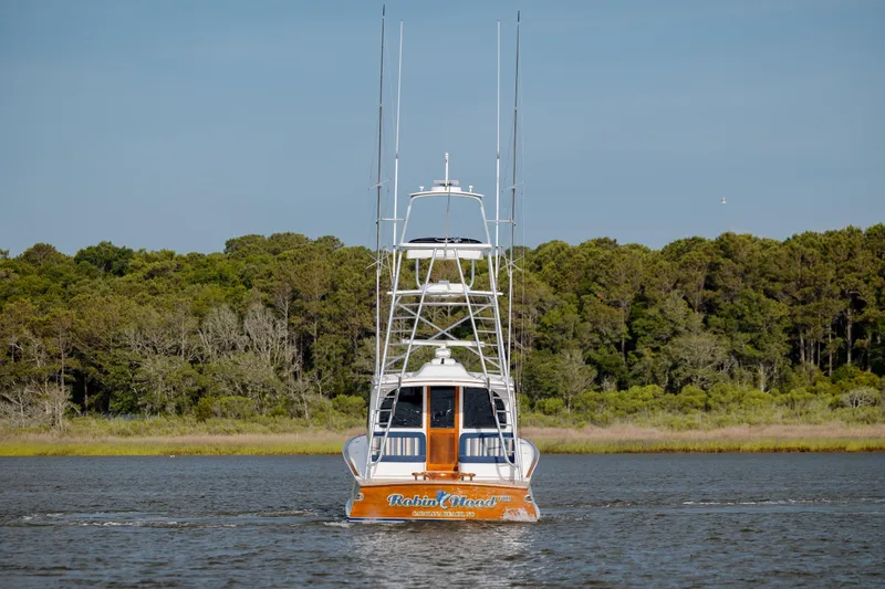 Slide: The Image of 2015 Jarrett Bay Hardtop Express Sportfish on calm water, forested shoreline in background. - 10
