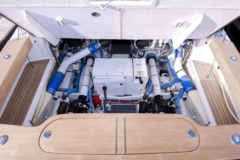 Slide: The Image of Engine compartment of 2015 Jarrett Bay Hardtop Express Sportfish with visible mechanical components. - 103