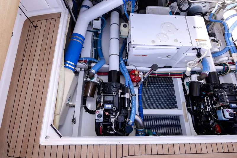 Slide: The Image of Engine room of a 2015 Jarrett Bay Hardtop Express Sportfish with visible machinery and components. - 105