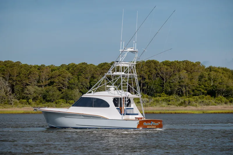 Slide: The Image of 2015 Jarrett Bay Hardtop Express Sportfish cruising on a serene waterway. - 11