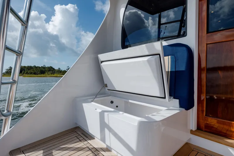 Slide: The Image of 2015 Jarrett Bay Hardtop Express Sportfish boat interior with open storage compartment. - 21
