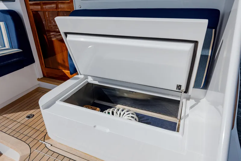 Slide: The Image of Open storage compartment on 2015 Jarrett Bay Hardtop Express Sportfish boat deck. - 23
