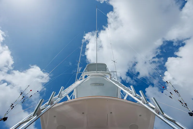 Slide: The Image of 2015 Jarrett Bay Hardtop Express Sportfish against a bright blue sky with clouds. - 24