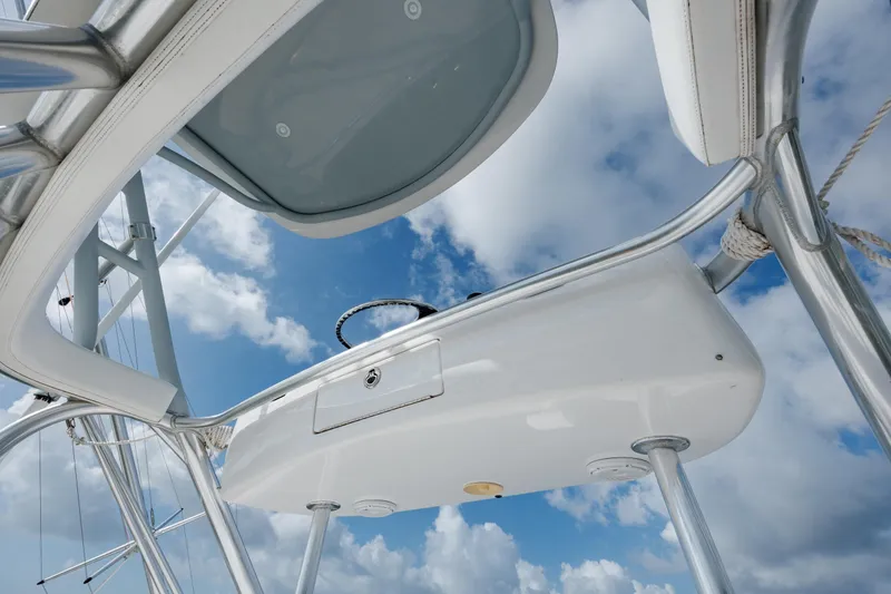 Slide: The Image of 2015 Jarrett Bay Hardtop Express Sportfish helm against a cloudy sky. - 28