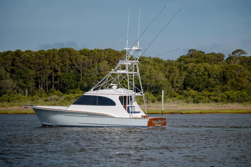 Slide: The Image of 2015 Jarrett Bay Hardtop Express Sportfish cruising on a serene waterway. - 3