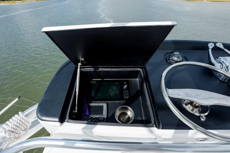 Slide: The Image of 2015 Jarrett Bay Hardtop Express Sportfish helm with navigation equipment and steering wheel. - 30