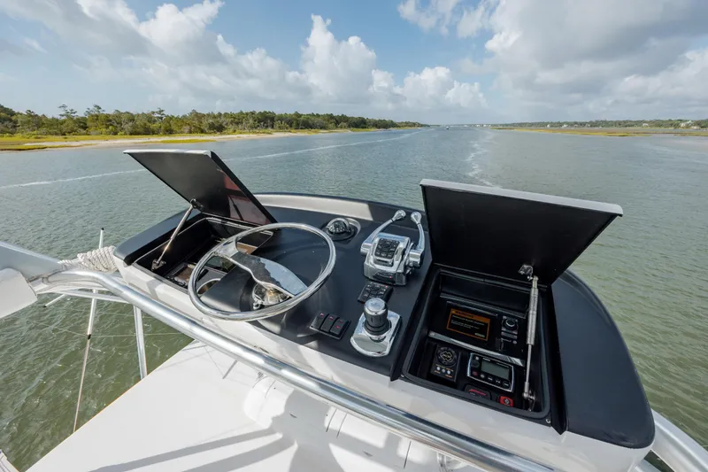 Slide: The Image of 2015 Jarrett Bay Hardtop Express Sportfish helm with steering wheel and navigation controls. - 31