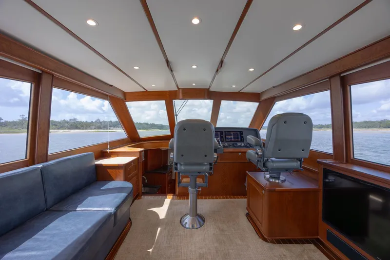 Slide: The Image of 2015 Jarrett Bay Hardtop Express Sportfish interior with helm, seating, and panoramic windows. - 36
