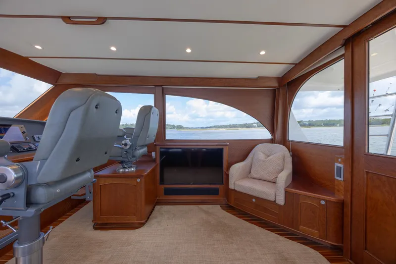 Slide: The Image of 2015 Jarrett Bay Hardtop Express Sportfish interior with helm chairs and scenic windows. - 39