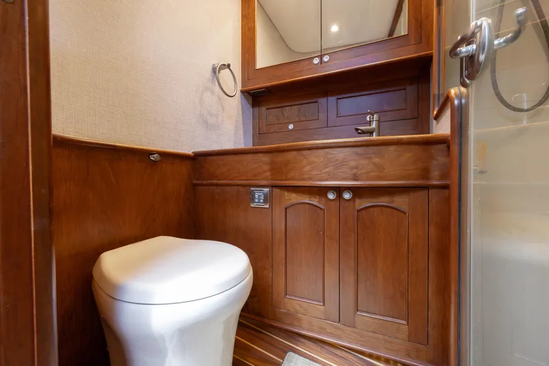Slide: The Image of Luxurious wooden bathroom interior on 2015 Jarrett Bay Hardtop Express Sportfish yacht. - 55