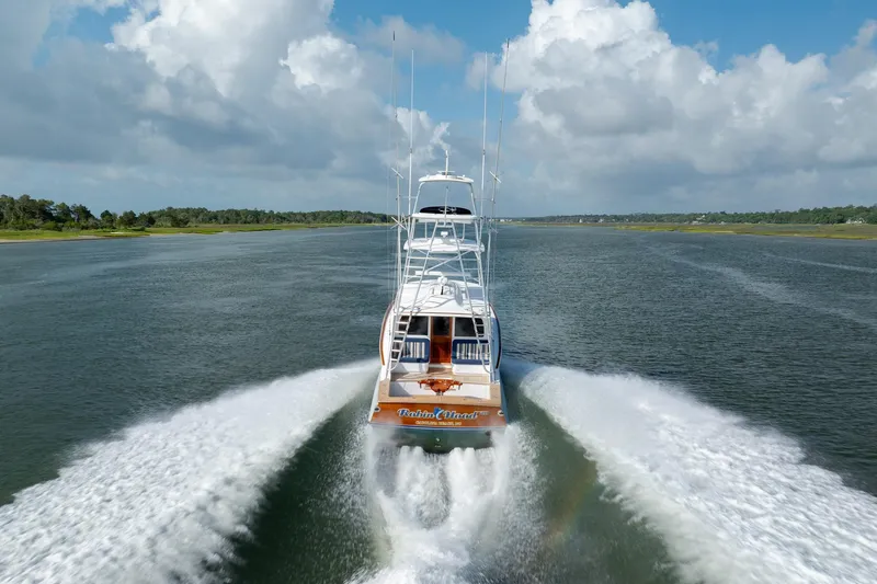 Slide: The Image of 2015 Jarrett Bay Hardtop Express Sportfish cruising on open water under cloudy skies. - 64