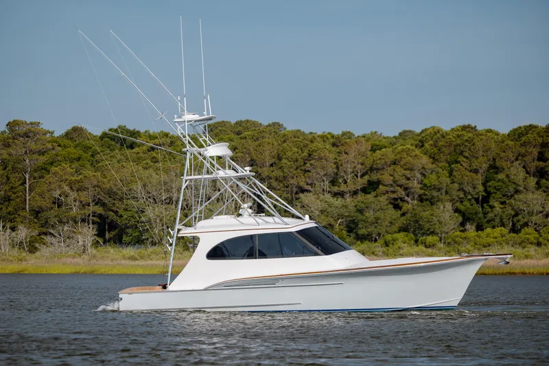 Slide: The Image of 2015 Jarrett Bay Hardtop Express Sportfish cruising on a serene waterway. - 7