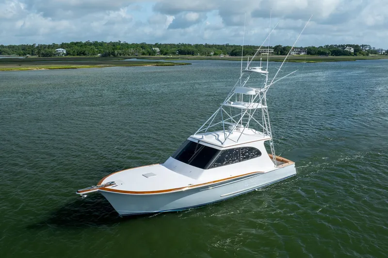 Slide: The Image of 2015 Jarrett Bay Hardtop Express Sportfish cruising on calm waters under a cloudy sky. - 78