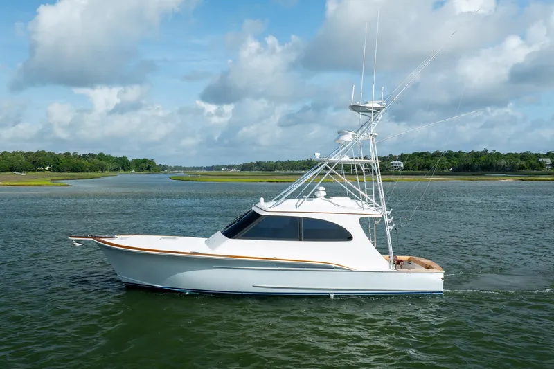 Slide: The Image of 2015 Jarrett Bay Hardtop Express Sportfish cruising on a scenic waterway under a blue sky. - 79