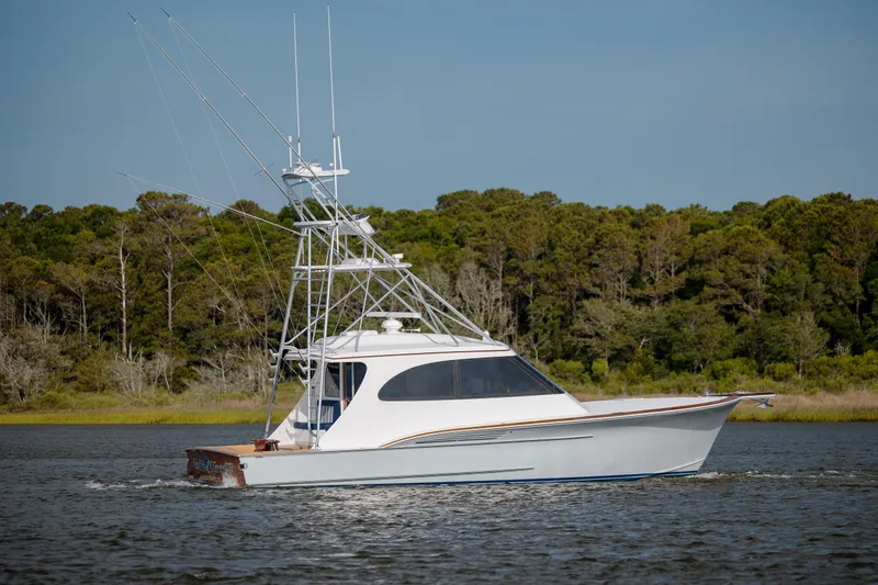 Slide: The Image of 2015 Jarrett Bay Hardtop Express Sportfish cruising on a serene waterway. - 8