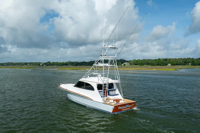 Slide: The Image of 2015 Jarrett Bay Hardtop Express Sportfish on calm waters under cloudy sky. - 80