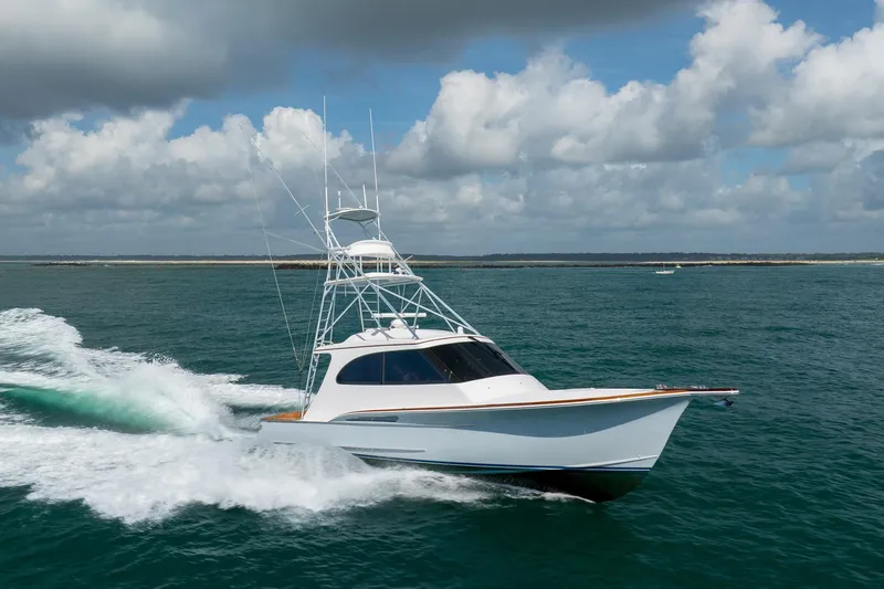 Slide: The Image of 2015 Jarrett Bay Hardtop Express Sportfish cruising on open water under cloudy skies. - 82