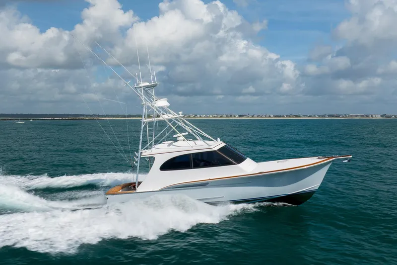 Slide: The Image of 2015 Jarrett Bay Hardtop Express Sportfish cruising on open water under cloudy skies. - 83