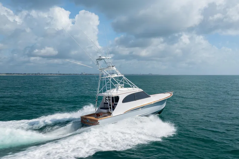 Slide: The Image of 2015 Jarrett Bay Hardtop Express Sportfish cruising on open ocean under cloudy sky. - 84