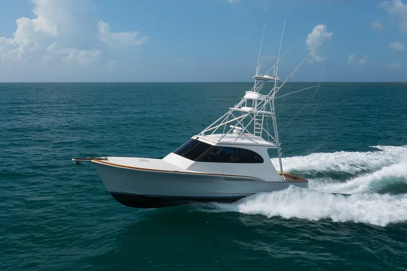 Slide: The Image of 2015 Jarrett Bay Hardtop Express Sportfish cruising on open ocean under clear skies. - 88