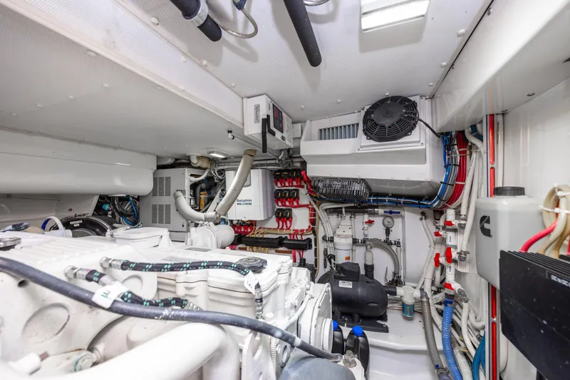 Slide: The Image of Engine room of 2015 Jarrett Bay Hardtop Express Sportfish, showcasing mechanical systems and wiring. - 95