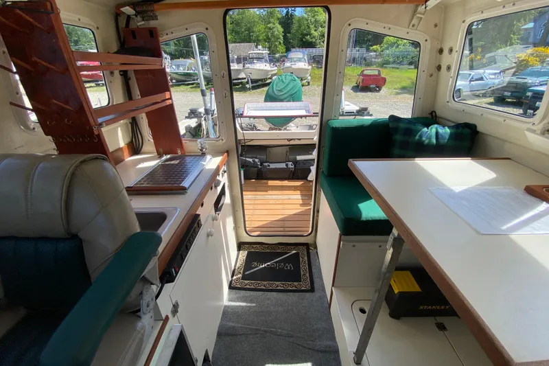 Slide: The Image of Interior view of a 1999 C-Dory 22' Angler boat with storage compartment. - 10